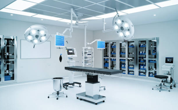 Modern ambulatory surgery center operating room with dual LED surgical lights, integrated AV monitor arms, surgical table, anesthesia equipment, and supply storage cabinets — designed and equipped by ALIS Technology